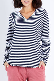 Model Andrea wearing size 10 of the Fundamental Coles Bay Henley in colour Whitenavy (Blue), from the front, cropped image