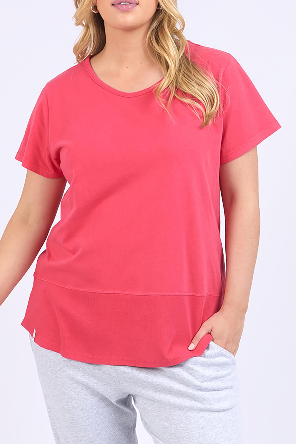 A model wearing the Fundamental Rib Short Sleeve Cotton Tee in colour Bitterred (Red), from the front, cropped image