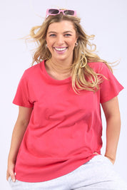 A model wearing the Fundamental Rib Short Sleeve Cotton Tee in colour Bitterred (Red), from the front, cropped image
