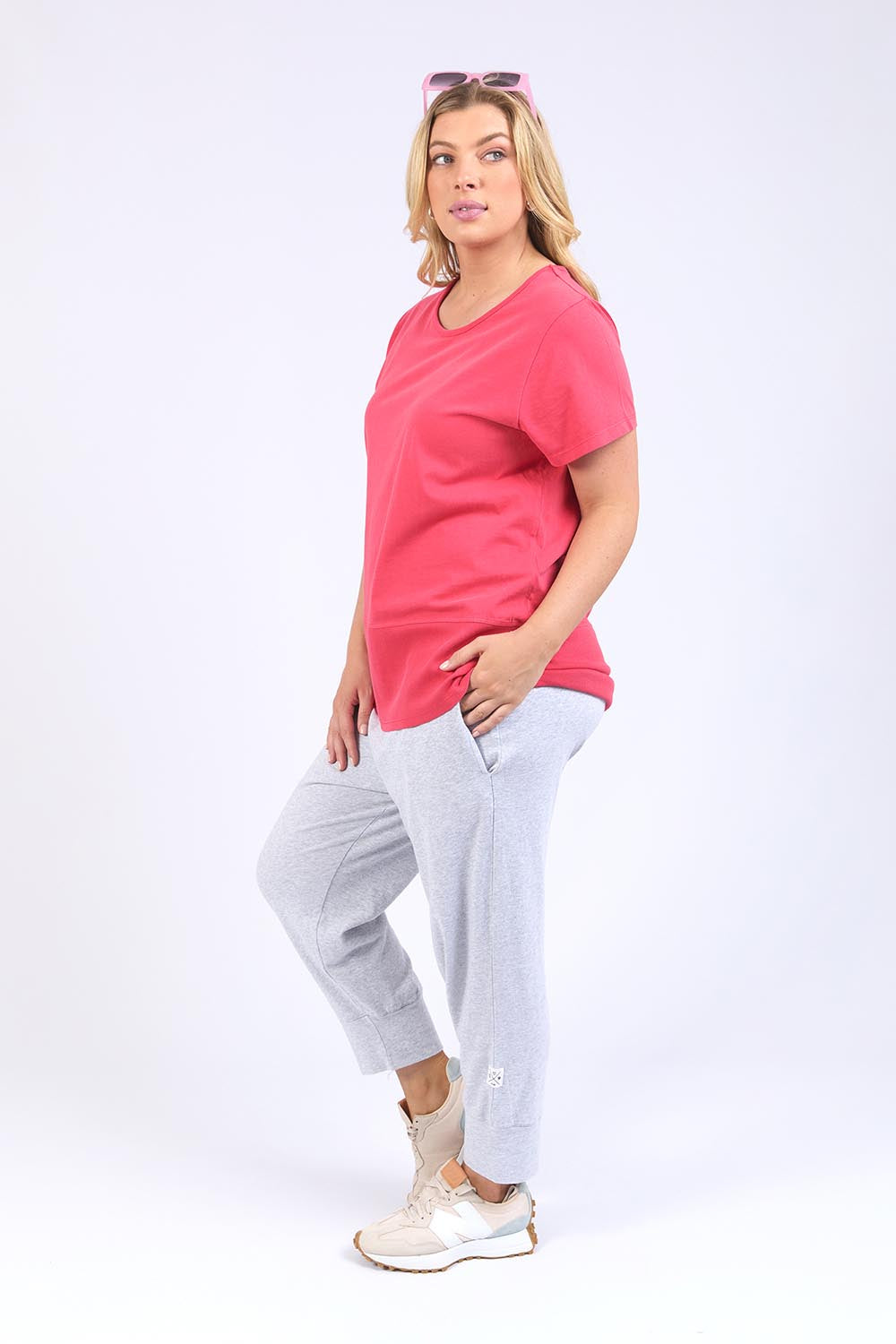 A model wearing the Fundamental Rib Short Sleeve Cotton Tee in colour Bitterred (Red), from the front, showing the whole outfit