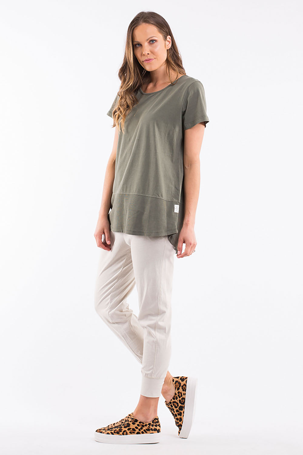 A model wearing the Fundamental Rib Short Sleeve Cotton Tee in colour Khaki (Green), from the front, showing the whole outfit