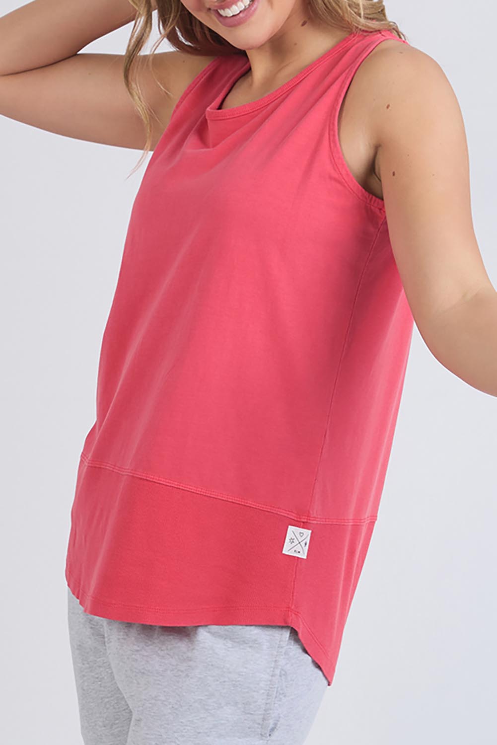 A model wearing the Fundamental Rib Cotton Tank in colour Bitterred (Red), from the front, cropped image
