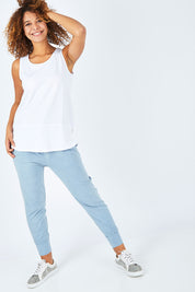 Model Summer wearing size 10 of the Fundamental Rib Cotton Tank in colour White (White), from the front, showing the whole outfit