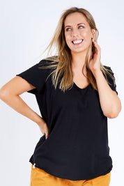Model Jess wearing size 14 of the Fundamental Vee Cotton Tee in colour Black (Black), from the front, cropped image