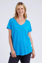 A model wearing the Fundamental Vee Cotton Tee in colour Ibizablue (Blue), from the front, cropped image