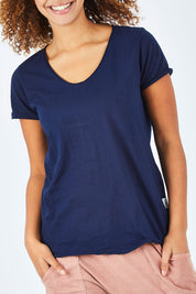 Model Summer wearing size 10 of the Fundamental Vee Cotton Tee in colour Navy (Blue), from the front, cropped image