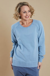 Model Steph wearing size 10 of the Fundamental Sydney Crew in colour Bluemist (Blue), from the front, cropped image