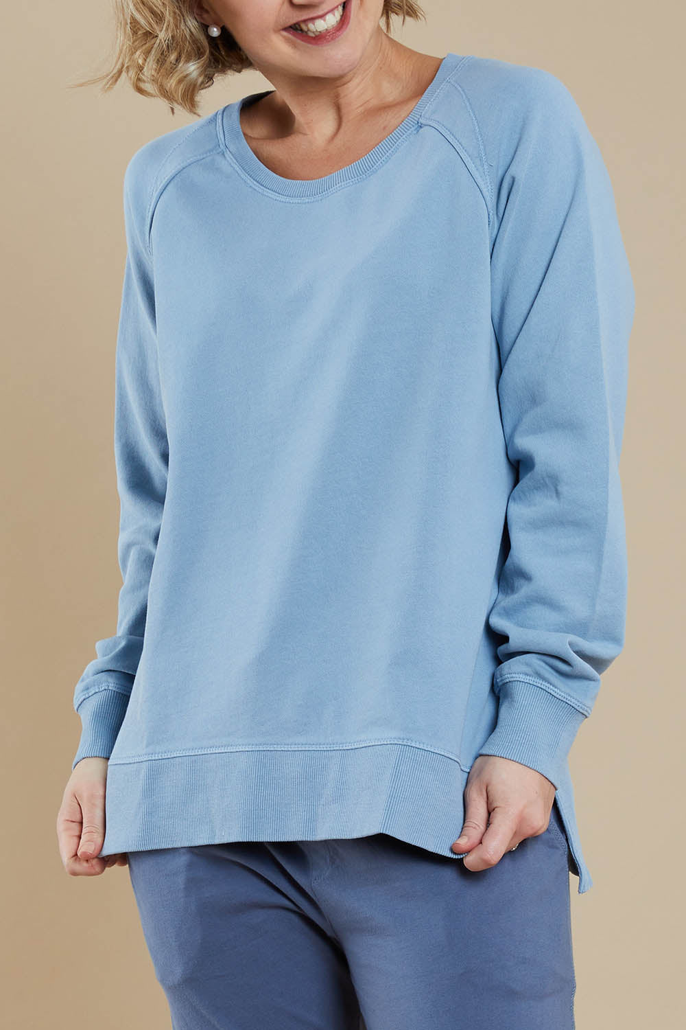 Model Steph wearing size 10 of the Fundamental Sydney Crew in colour Bluemist (Blue), from the front, cropped image