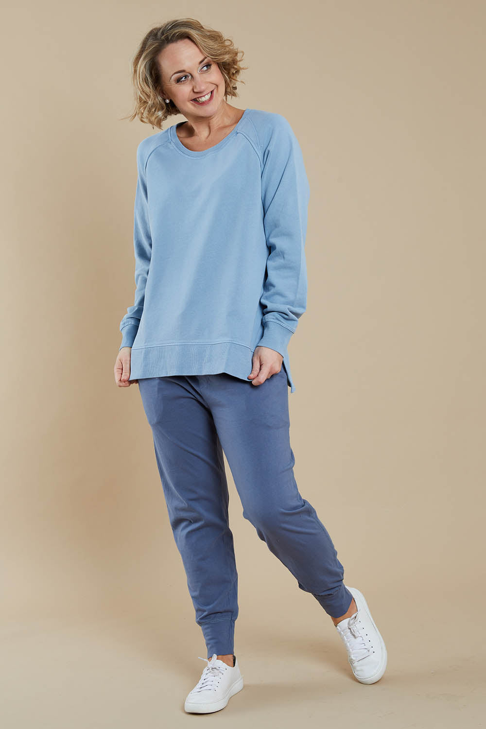 Model Steph wearing size 10 of the Fundamental Sydney Crew in colour Bluemist (Blue), from the front, showing the whole outfit