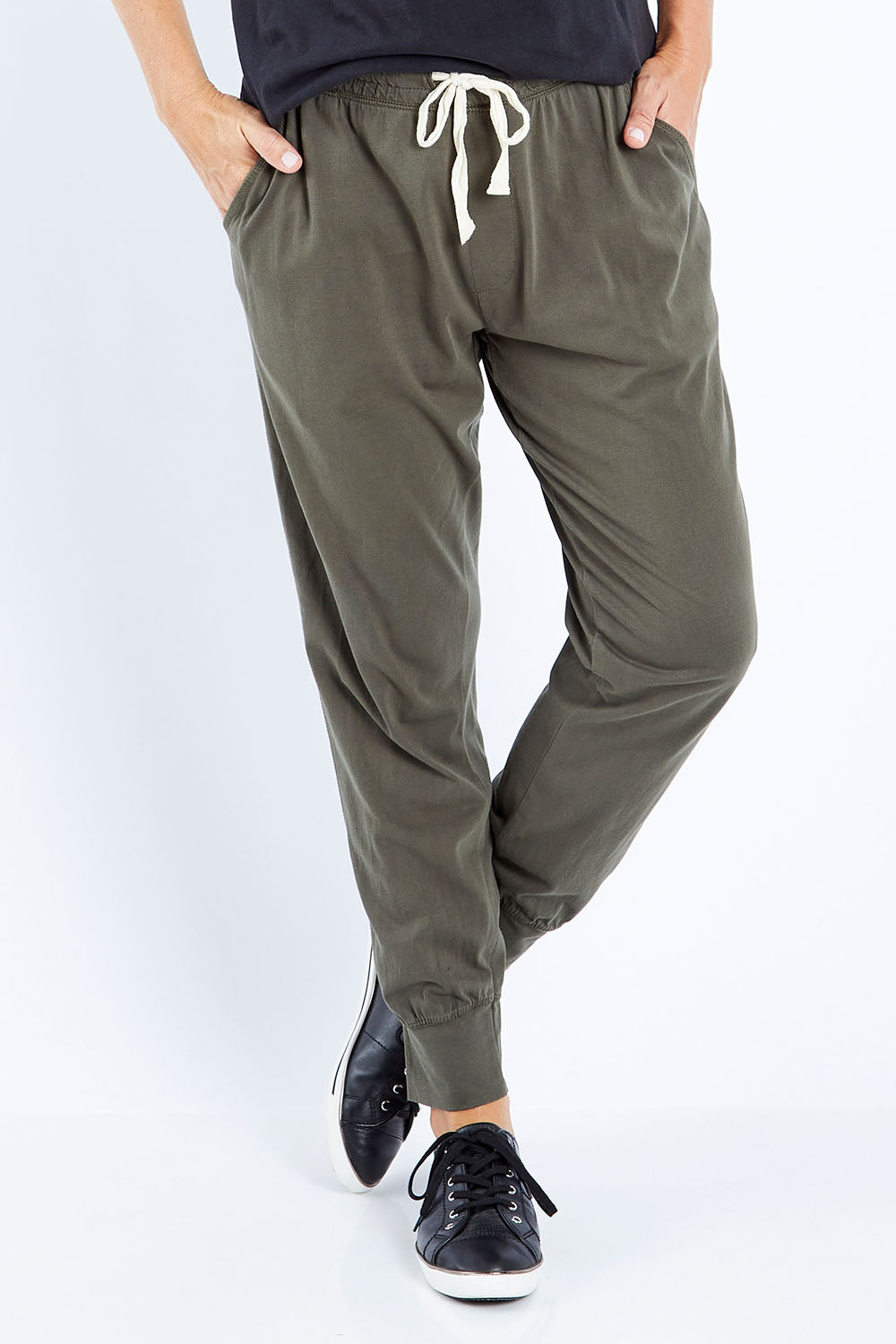 Model Bianca wearing size 10 of the Fundamental Wash Out Pant in colour Darkkhaki (Green), from the front, cropped image