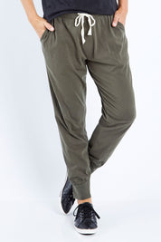 Model Bianca wearing size 10 of the Fundamental Wash Out Pant in colour Darkkhaki (Green), from the front, cropped image
