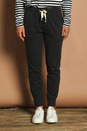 Model Katie wearing size 10 of the Fundamental Wash Out Pant in colour Navy (Blue), from the front, cropped image