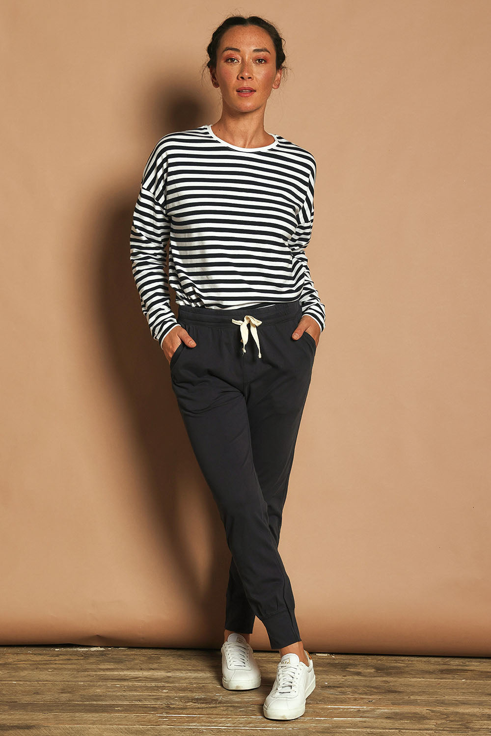Model Katie wearing size 10 of the Fundamental Wash Out Pant in colour Navy (Blue), from the front, showing the whole outfit