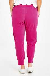 Model Laura wearing size 14 of the Fundamental Wash Out Pant in colour Plum (Pink), from the back