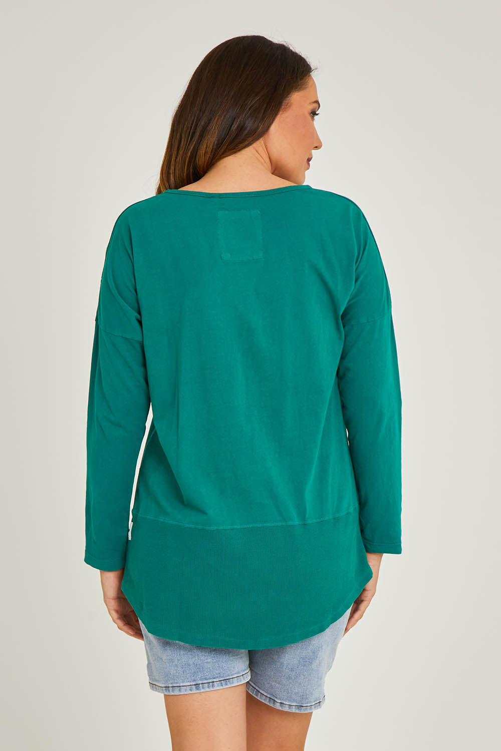 Model Georgia wearing size 10 of the Fundamental Rib Long Sleeve Tee in colour Brightgrn (Green), from the back