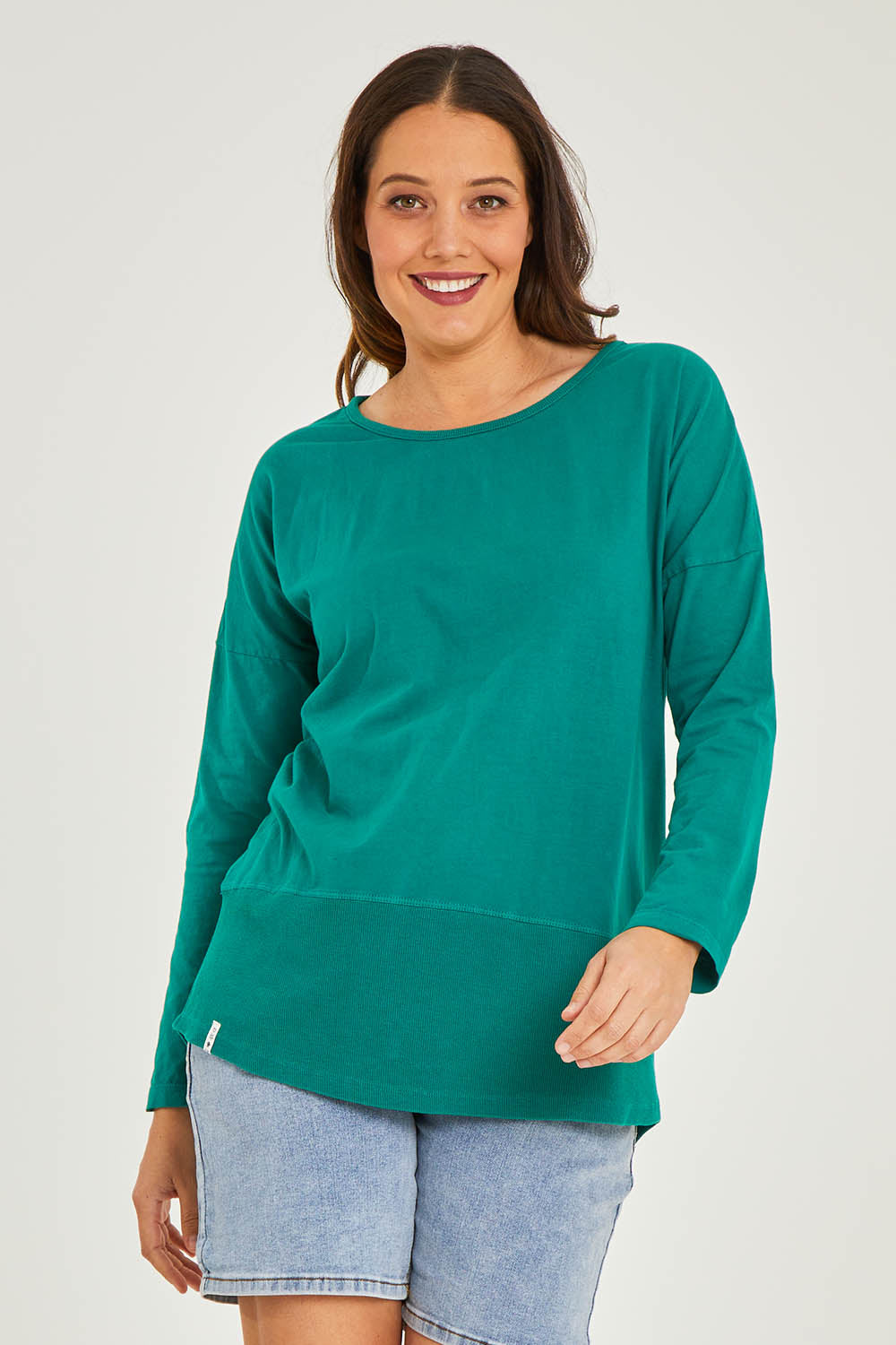 Model Georgia wearing size 10 of the Fundamental Rib Long Sleeve Tee in colour Brightgrn (Green), from the front, cropped image