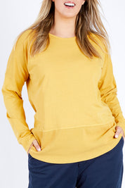 Model Jess wearing size 14 of the Fundamental Rib Long Sleeve Tee in colour Mustard, from the front, cropped image
