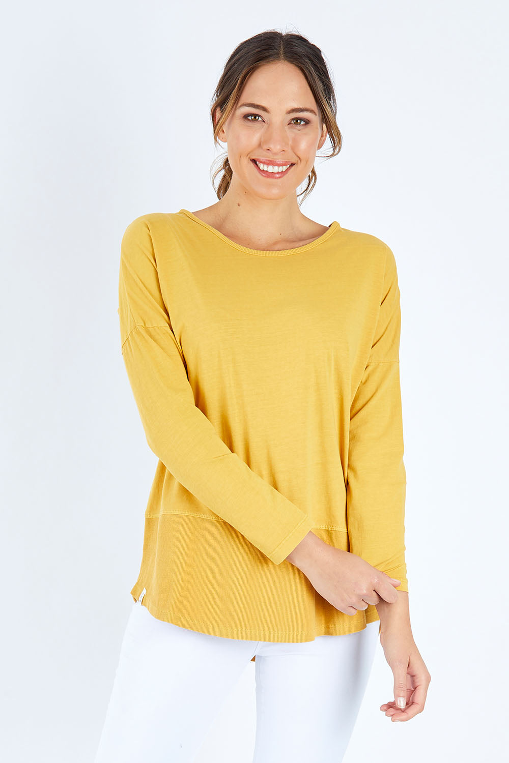Model Madeline wearing size 10 of the Fundamental Rib Long Sleeve Tee in colour Mustard, from the front, cropped image
