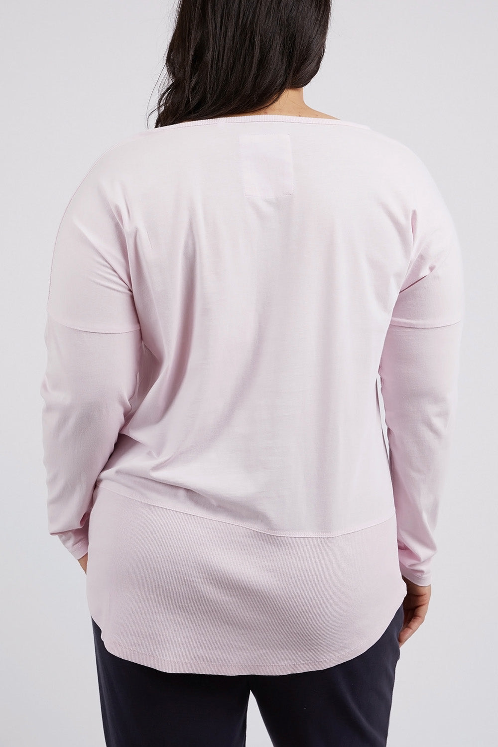 A model wearing the Fundamental Rib Long Sleeve Tee in colour Powderpink (Pink), from the back