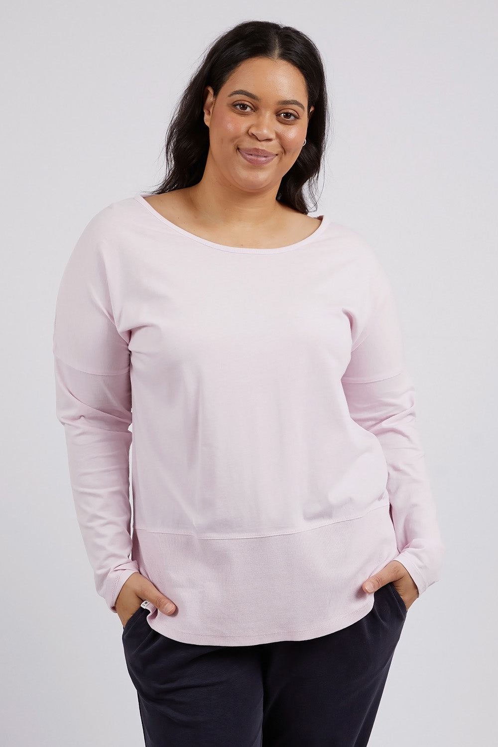 A model wearing the Fundamental Rib Long Sleeve Tee in colour Powderpink (Pink), from the front, cropped image