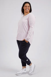 A model wearing the Fundamental Rib Long Sleeve Tee in colour Powderpink (Pink), from the front, showing the whole outfit