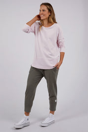 A model wearing the Fundamental Rib Long Sleeve Tee in colour Powderpink (Pink), from the front, showing the whole outfit