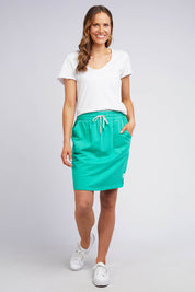 A model wearing the Fundamental Cassie Skirt in colour Brghtgreen (Green), from the front, showing the whole outfit