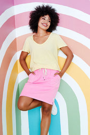 Model Olivia wearing size 10 of the Fundamental Cassie Skirt in colour Bubblegum (Pink), from the front, showing the whole outfit