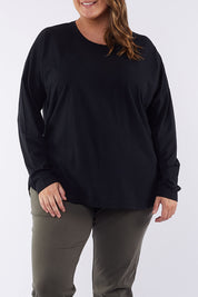A model wearing the Fundamental Society L/S Tee in colour Black (Black), from the front, cropped image