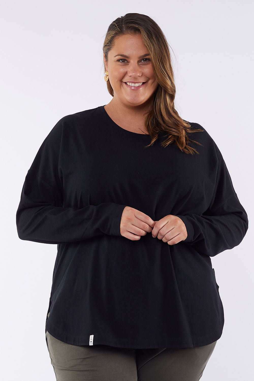 A model wearing the Fundamental Society L/S Tee in colour Black (Black), from the front, cropped image