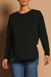 Model Katie wearing size 10 of the Fundamental Society L/S Tee in colour Black (Black), from the front, cropped image