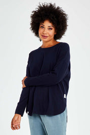 Model Olivia wearing size 10 of the Fundamental Society L/S Tee in colour Navy (Blue), from the front, cropped image