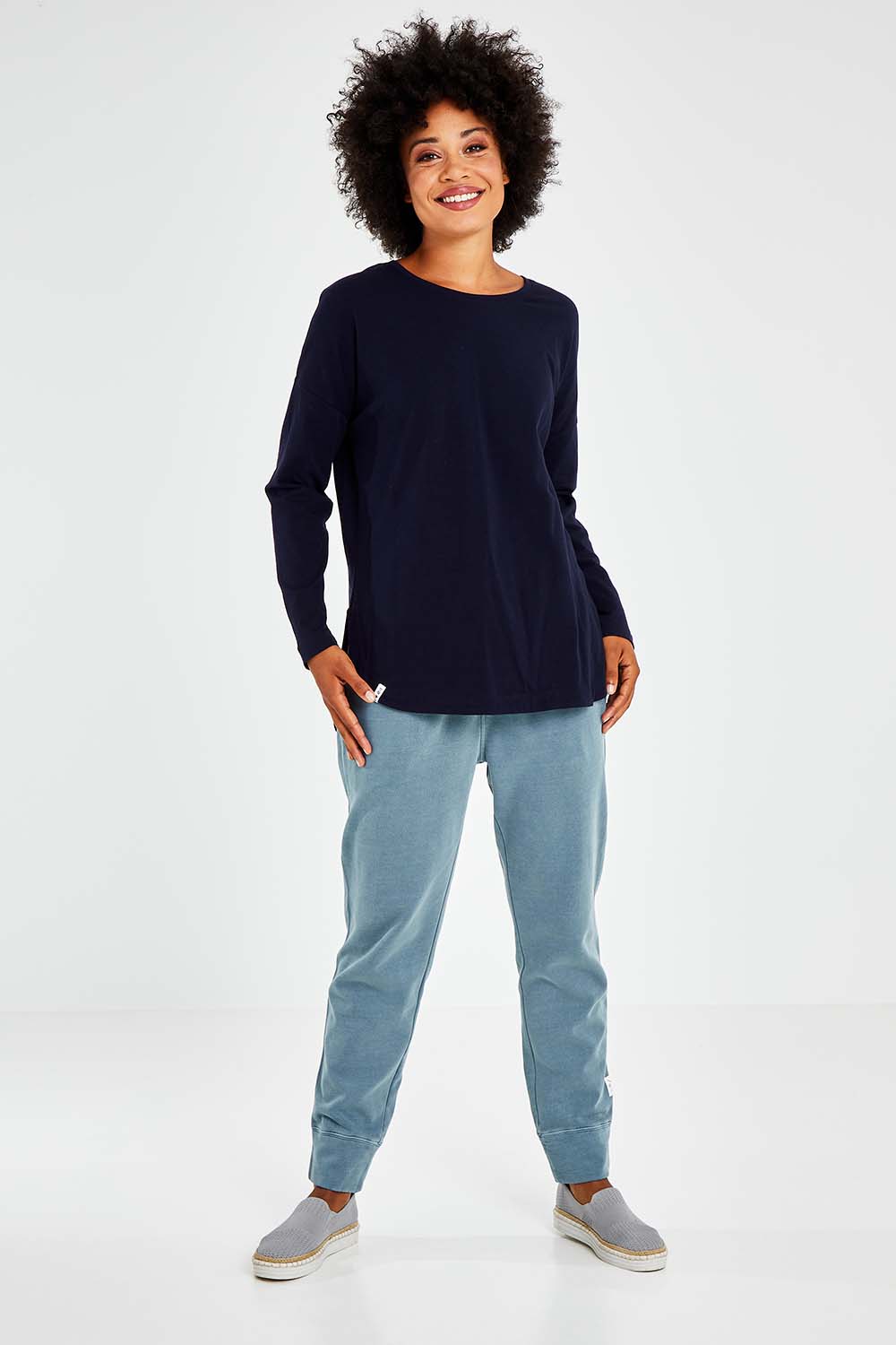 Model Olivia wearing size 10 of the Fundamental Society L/S Tee in colour Navy (Blue), from the front, showing the whole outfit