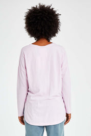 Model Olivia wearing size 10 of the Fundamental Society L/S Tee in colour Pink (Pink), from the back