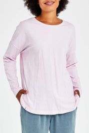 Model Olivia wearing size 10 of the Fundamental Society L/S Tee in colour Pink (Pink), from the front, cropped image