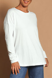 Model Katie wearing size 10 of the Fundamental Society L/S Tee in colour White (White), from the front, cropped image