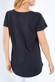 Model Bianca wearing size 10 of the Fundamental Crew Tail Tee in colour Black (Black), from the back