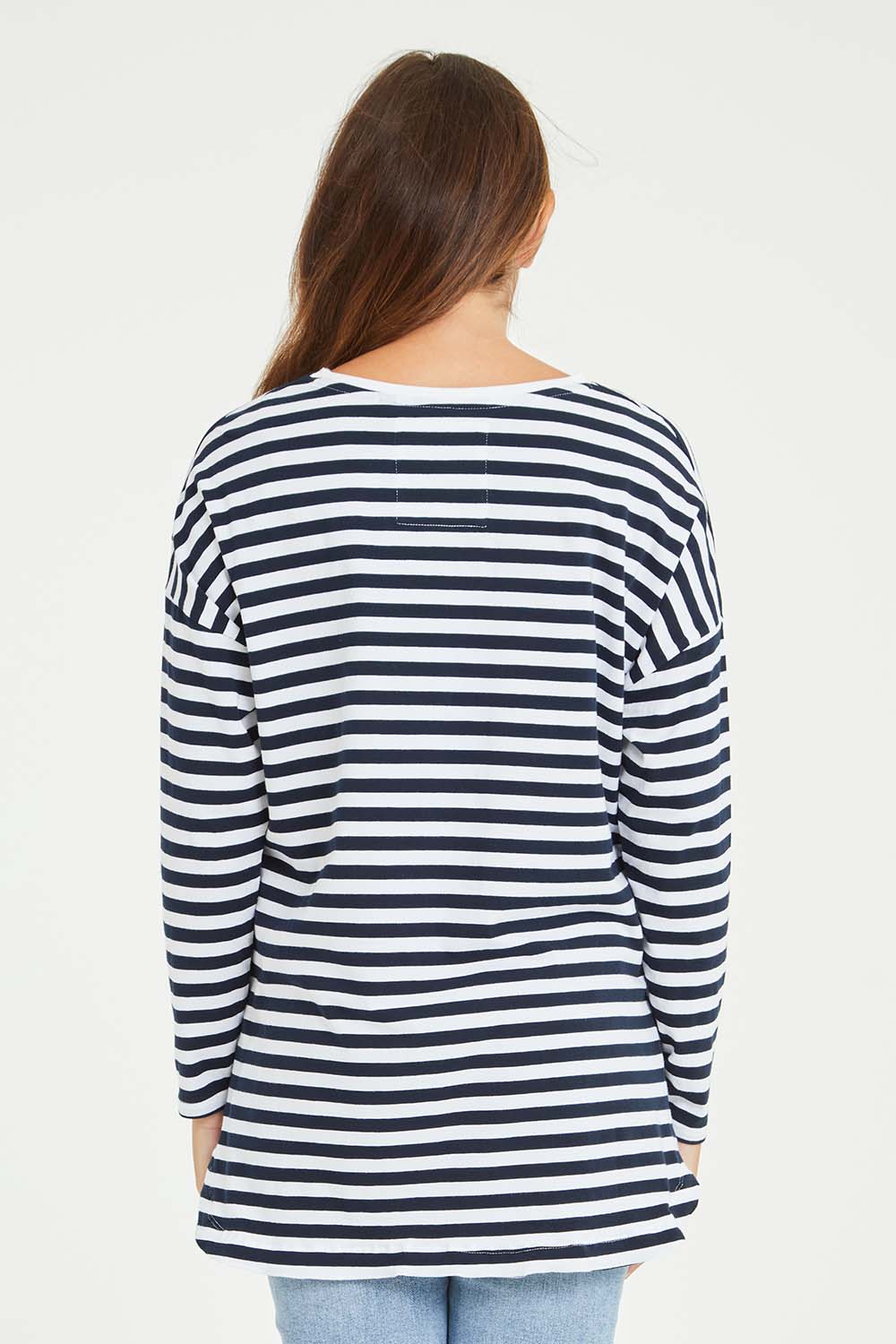 Model Tahlia wearing size 10 of the Fundamental Stripe Society L/S Tee in colour Navywhite (Blue), from the back