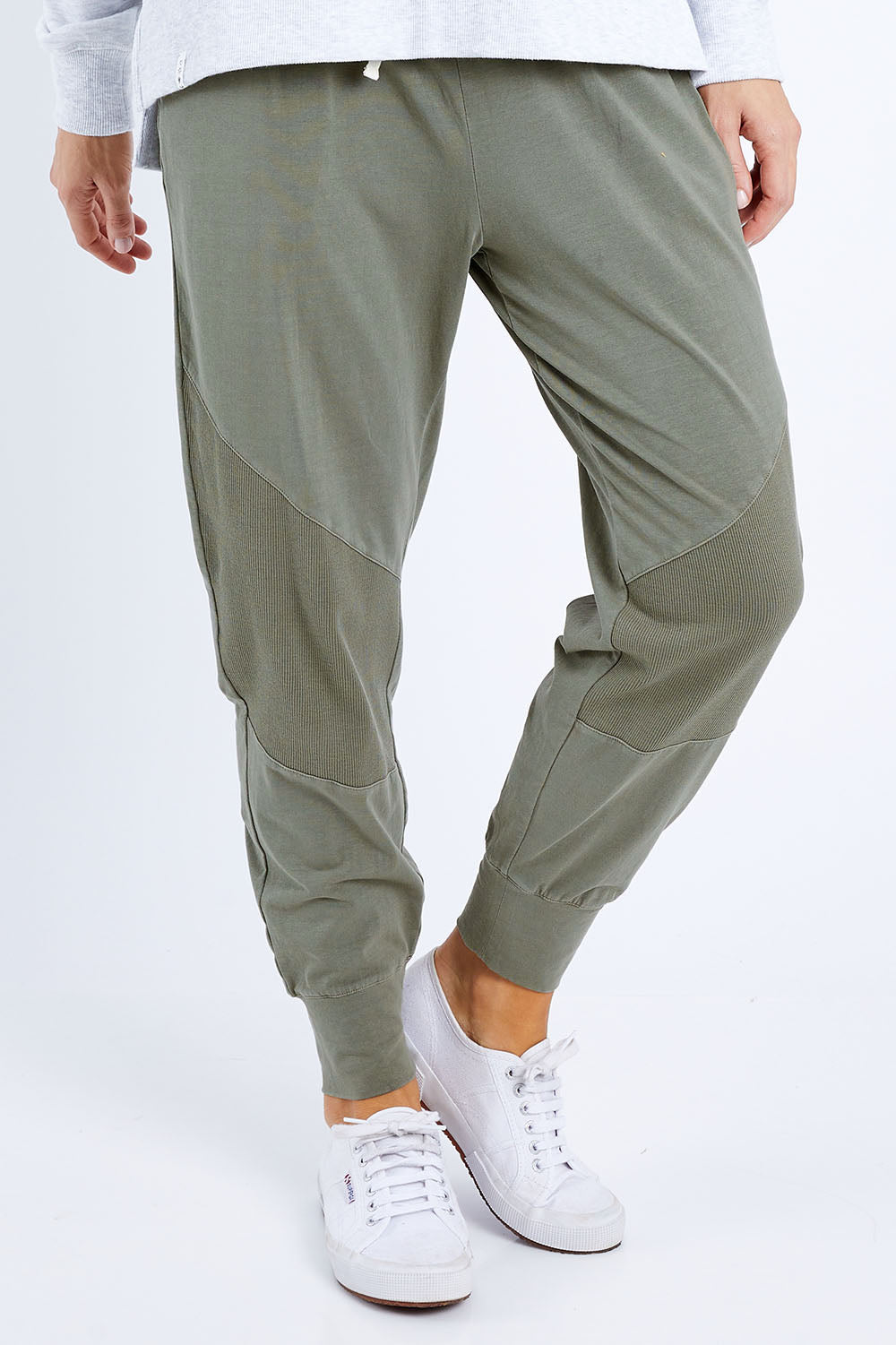 Model Andrea wearing size 10 of the Fundamental Rib Trim Pant in colour Khaki (Green), from the front, cropped image