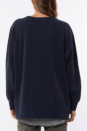 A model wearing the Fundamental Victoria Crew in colour Navy (Blue), from the back