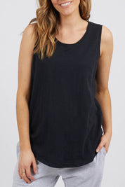 A model wearing the Fundamental Scoop Tank in colour Black (Black), from the front, cropped image