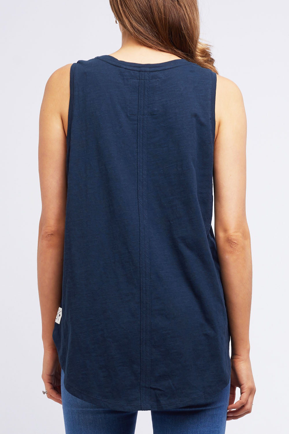 A model wearing the Fundamental Scoop Tank in colour Navy (Blue), from the back