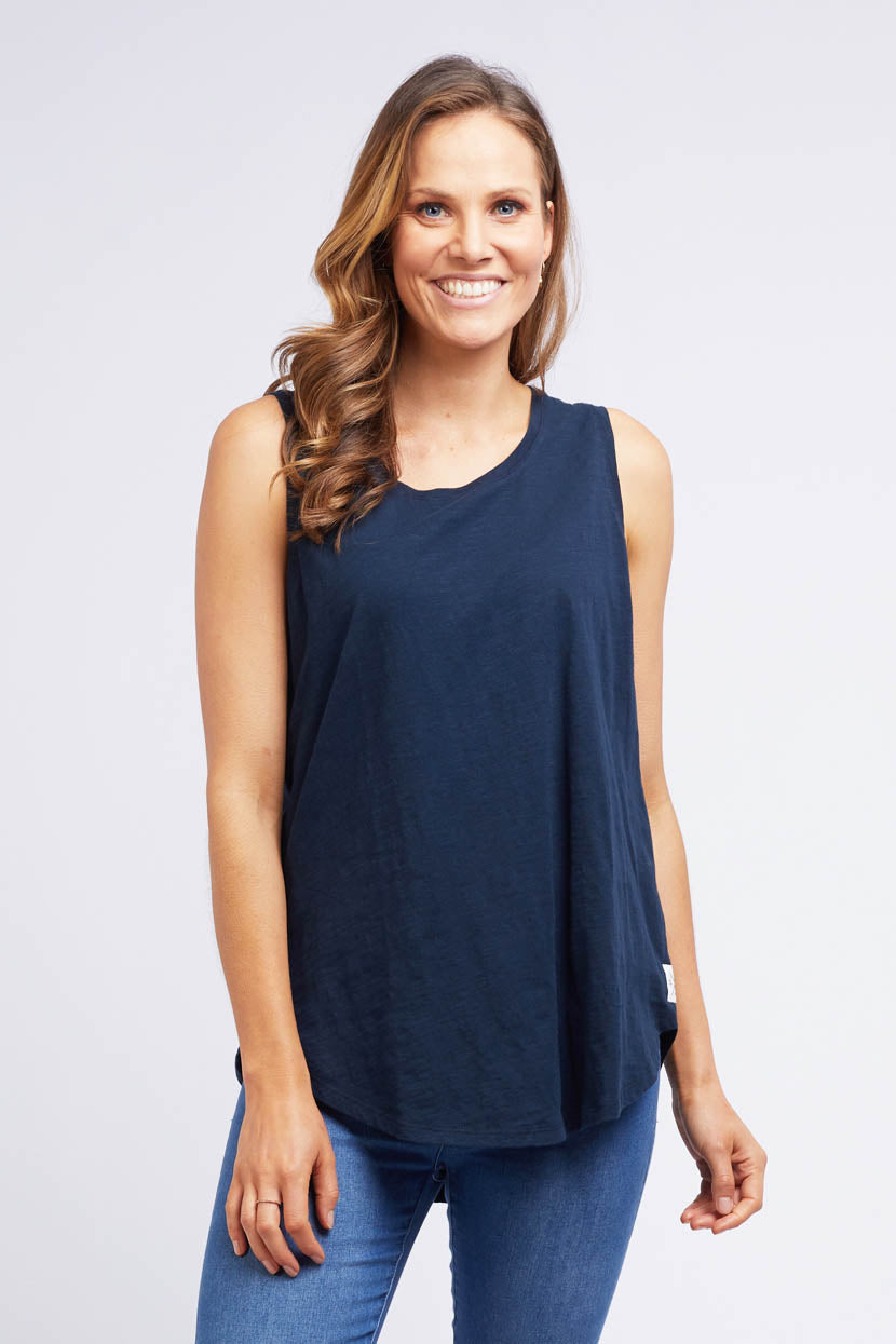 A model wearing the Fundamental Scoop Tank in colour Navy (Blue), from the front, cropped image