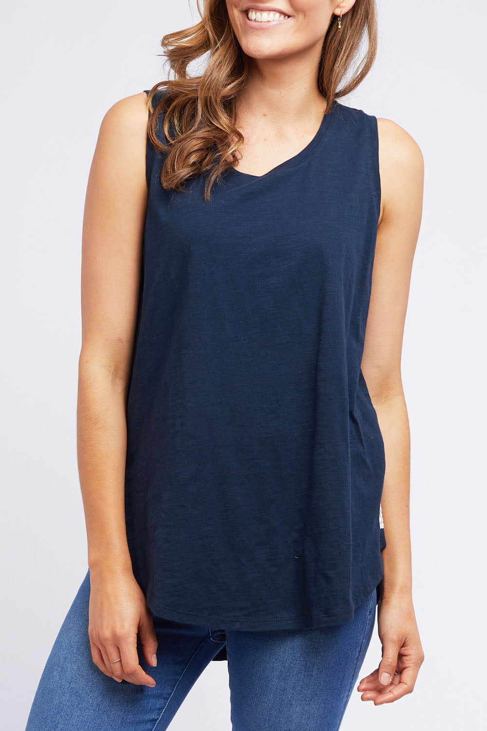A model wearing the Fundamental Scoop Tank in colour Navy (Blue), from the front, cropped image