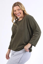 A model wearing the Fundamental Annie 3/4 Sleeve Tee in colour Basil (Green), from the front, cropped image