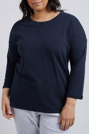 A model wearing the Fundamental Annie 3/4 Sleeve Tee in colour Navy (Blue), from the front, cropped image