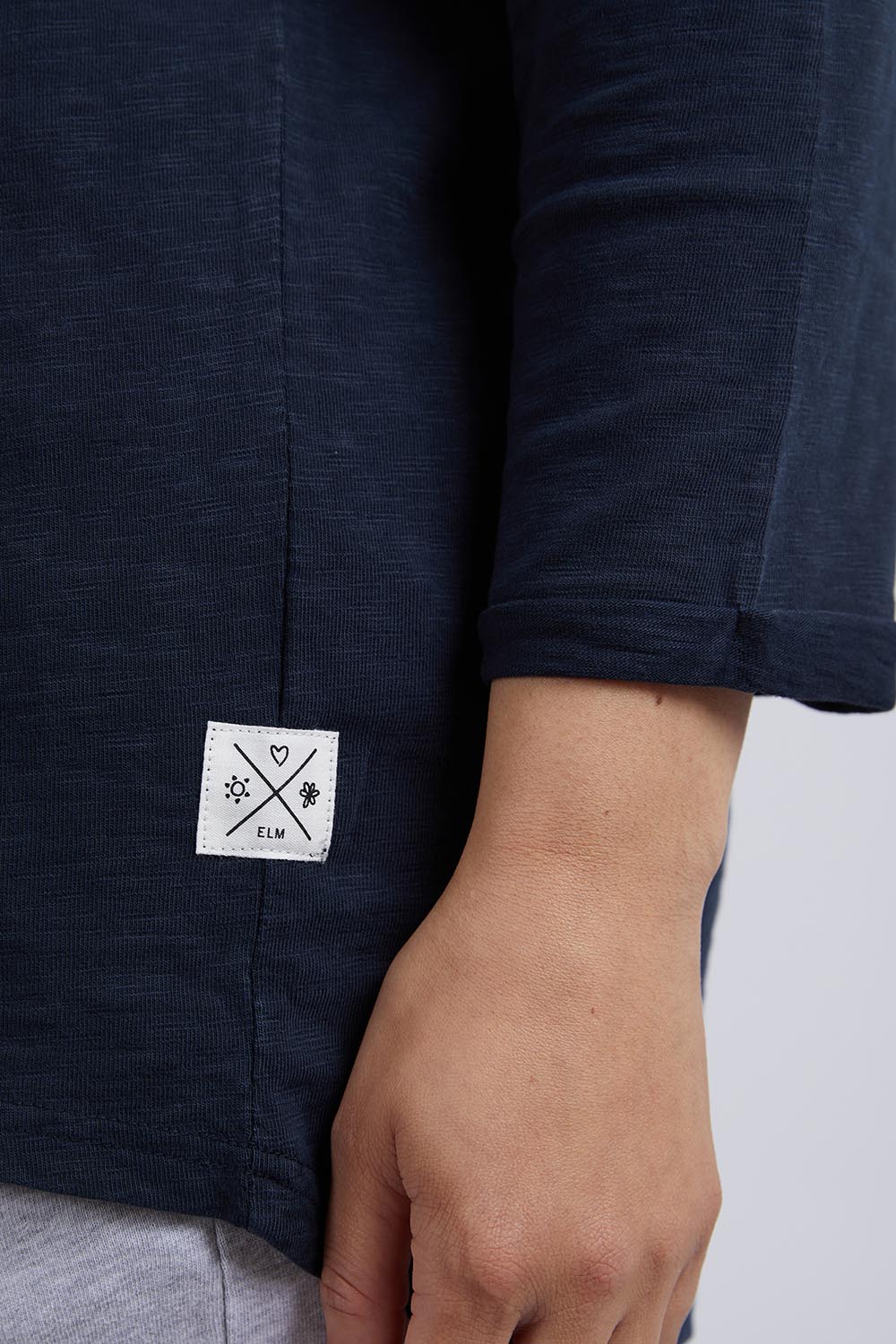 A model wearing the Fundamental Annie 3/4 Sleeve Tee in colour Navy (Blue), from the front, cropped image