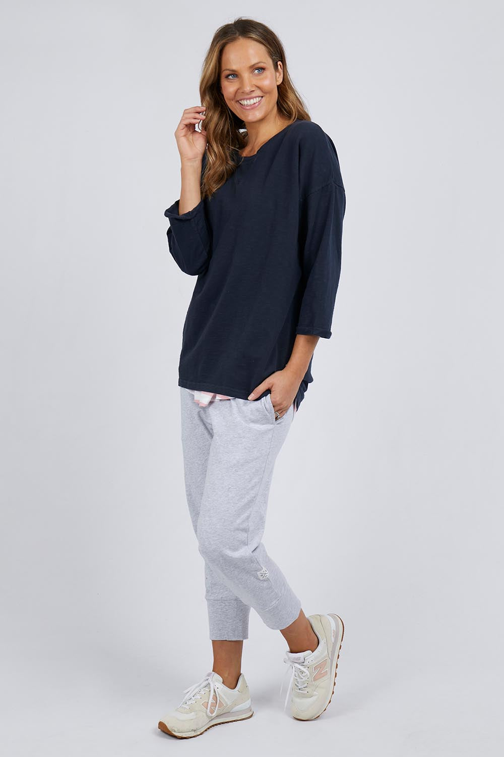 A model wearing the Fundamental Annie 3/4 Sleeve Tee in colour Navy (Blue), from the front, showing the whole outfit