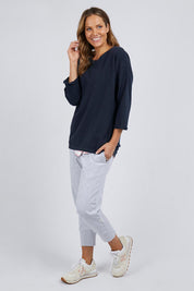 A model wearing the Fundamental Annie 3/4 Sleeve Tee in colour Navy (Blue), from the front, showing the whole outfit