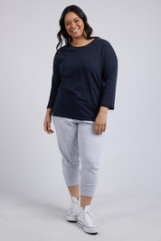 A model wearing the Fundamental Annie 3/4 Sleeve Tee in colour Navy (Blue), from the front, showing the whole outfit
